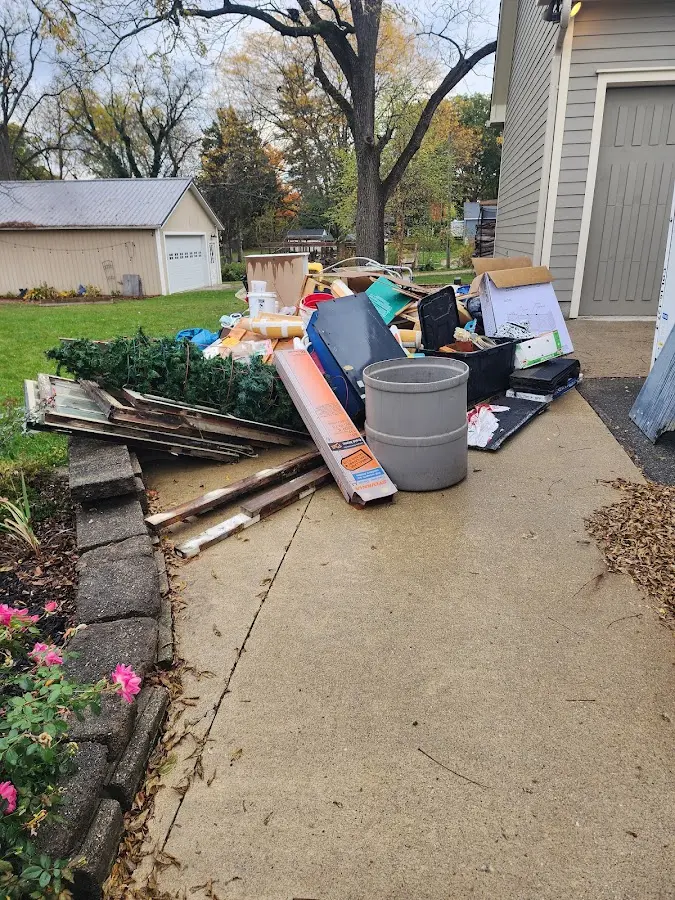 Dumpster being loaded with debris for 3 Yard Dumpster Rental in Pontotoc